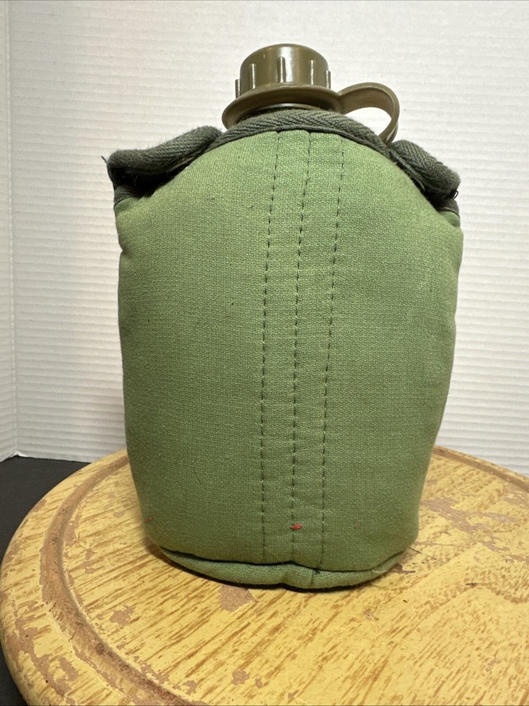 8" Green Plastic Canteen with Cloth Cover.
