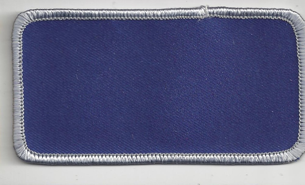 NAME TAG BLANK BLUE WITH GRAY-SILVER MERROWED EDGE                        J