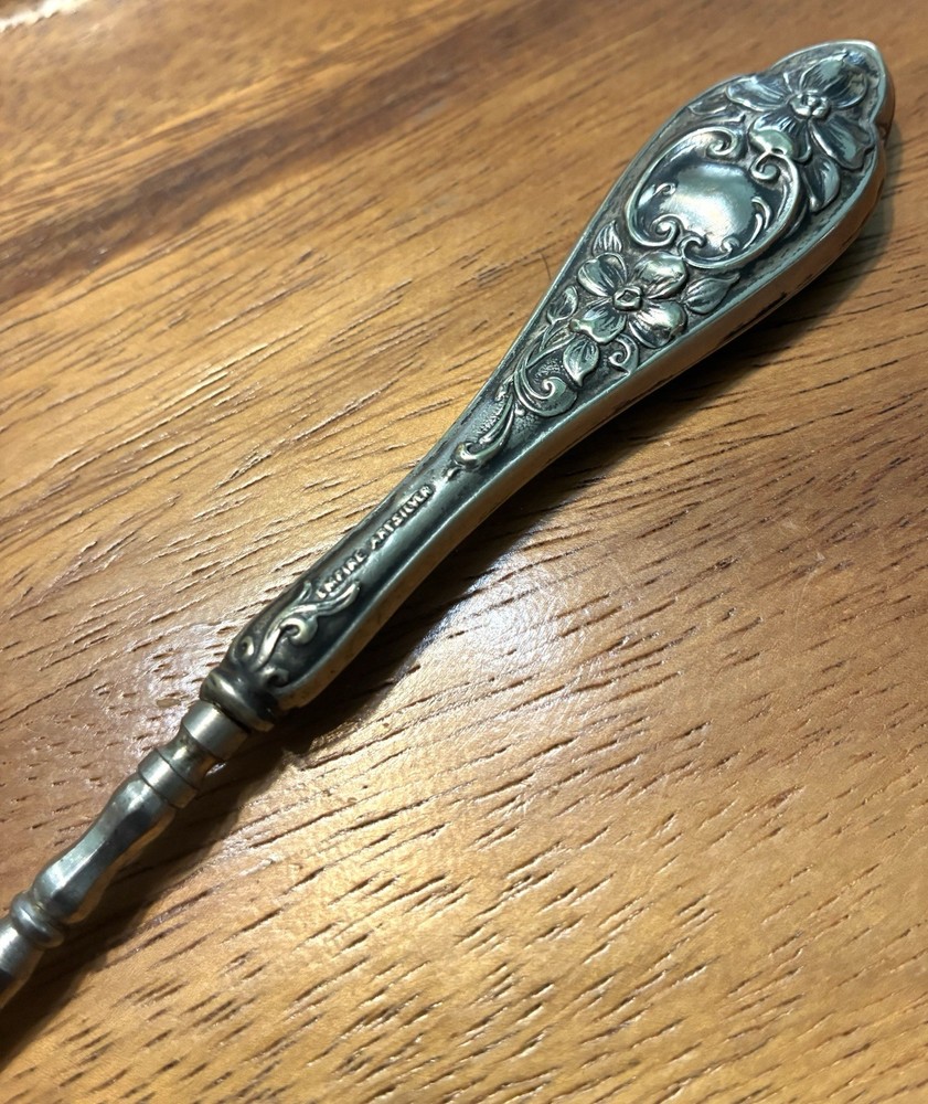 Ornate Empire Art Silver Plate Button Hook with a scrolled Victorian Handle.
