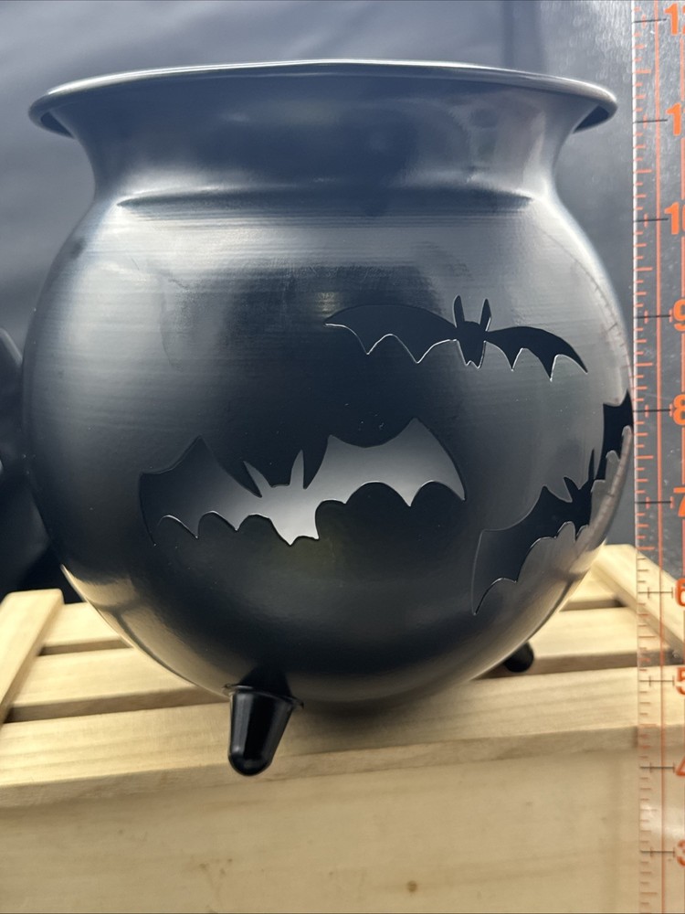 Metal Cauldron Has Bats Cut Out .