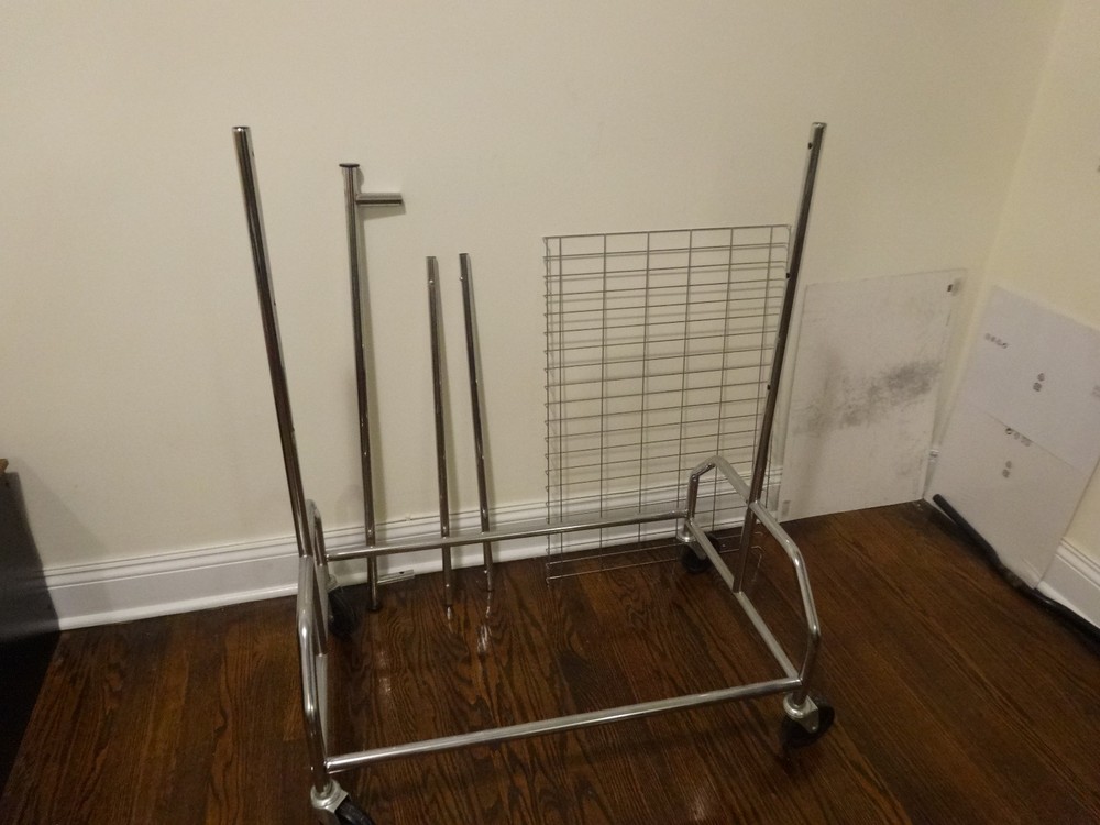 Used Heavy Duty Rolling Clothing/Garment Rack with wheels & mesh floor