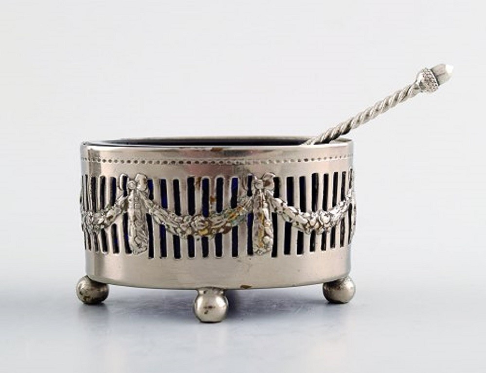Three Danish salt jars in silver with blue glass inserts and salt spoons.