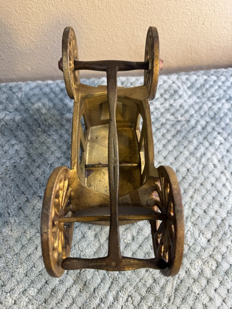 Antique cast iron pull toy carriage with decorative detailing and pull handle