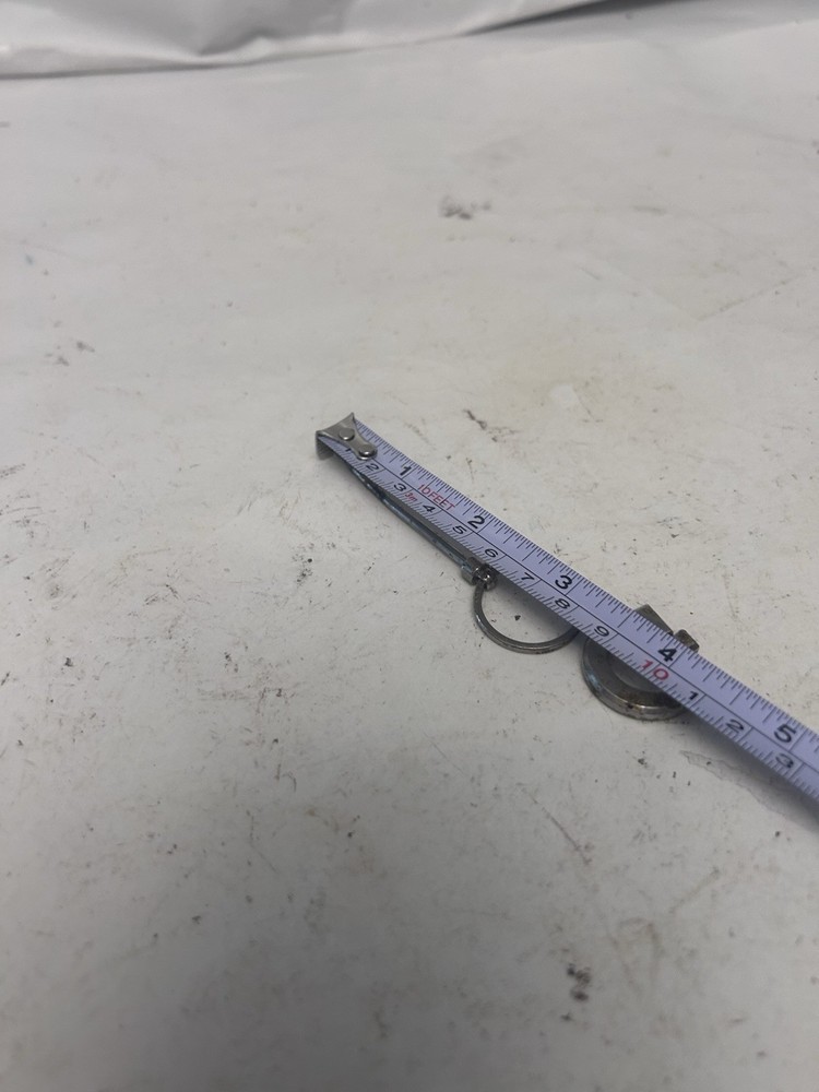 "G" keychain with small spoon scooper used