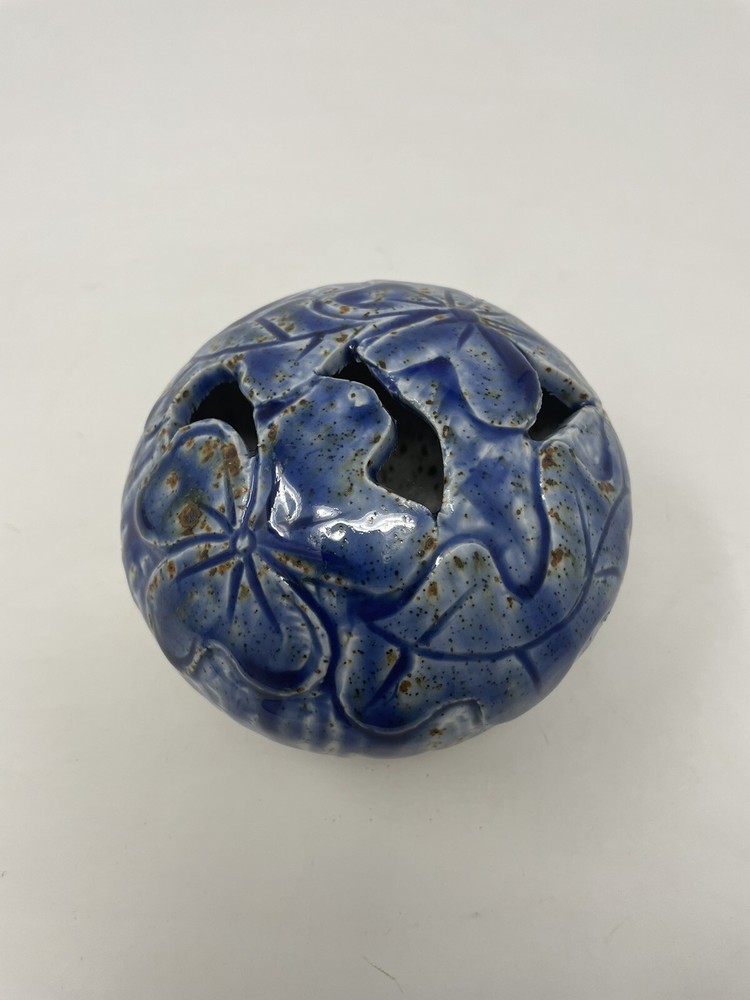 Pottery vase blue with brown specs .