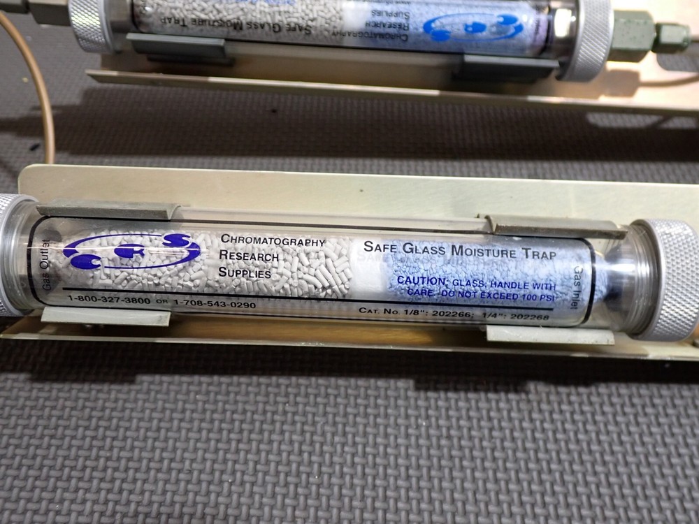 Gas flow regulators and desiccant