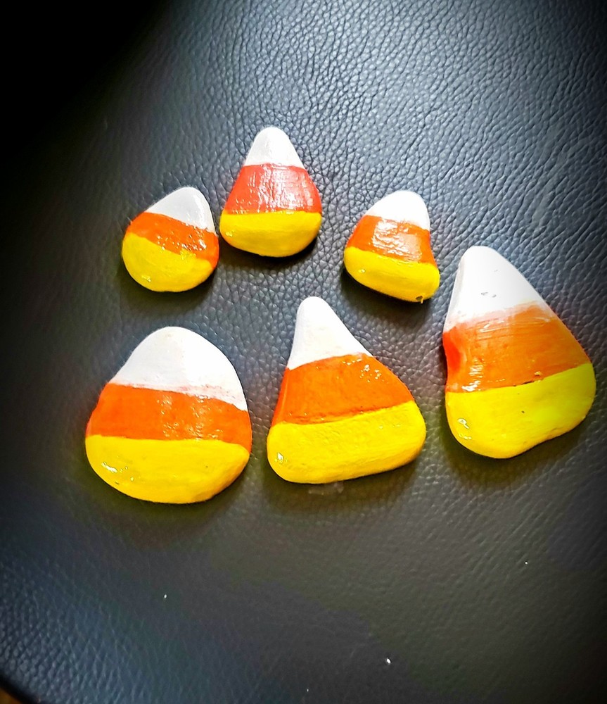 Hand Painted candy corn rocks.  Kindness Rocks