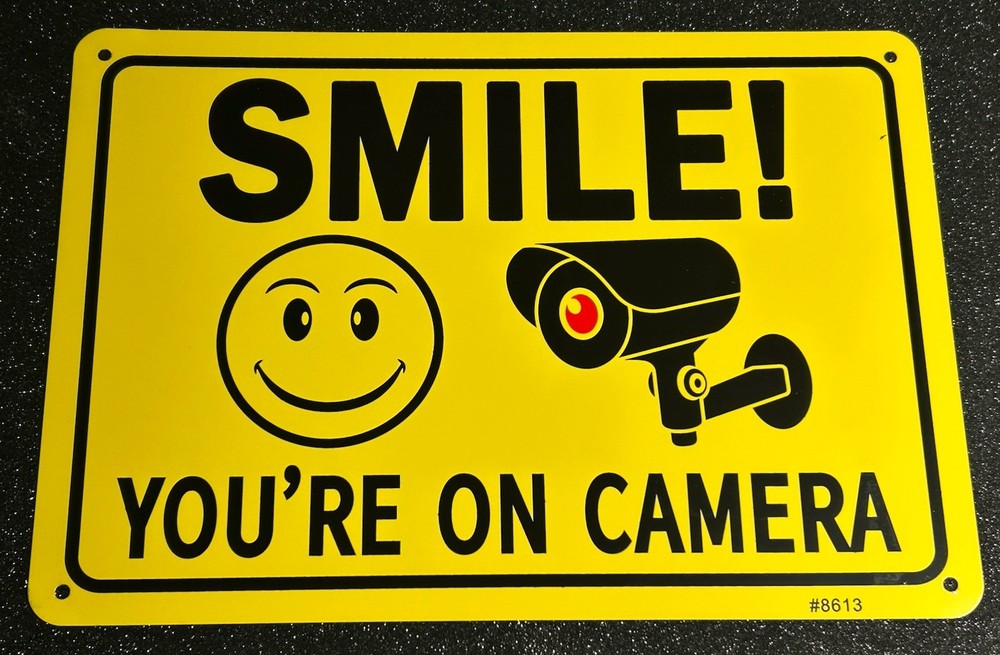 SMILE YOU'RE ON CAMERA/SIGN W HAPPY FACE &CAMERA