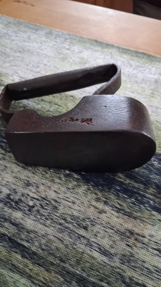 Antique 19th-century cast iron flat iron with a solid handle.