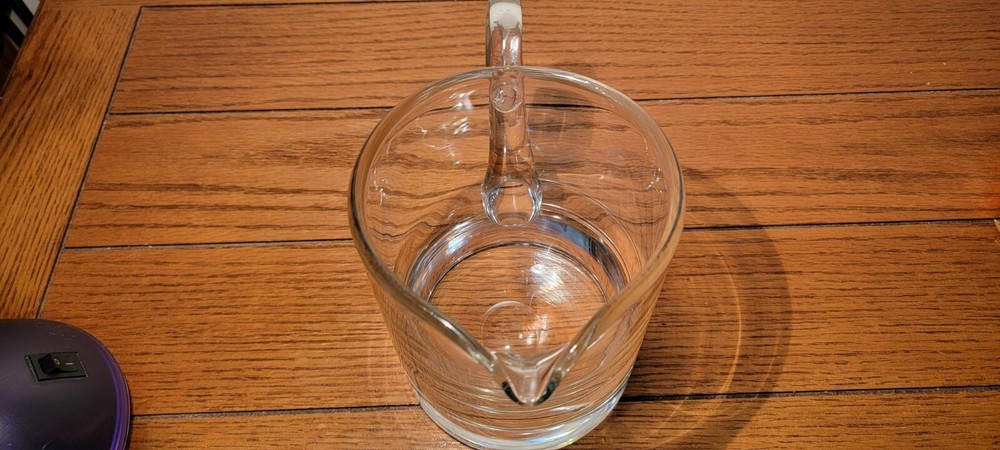 VINTAGE HAND BLOWN GLASS PITCHER WITH APPLIED HANDLE.