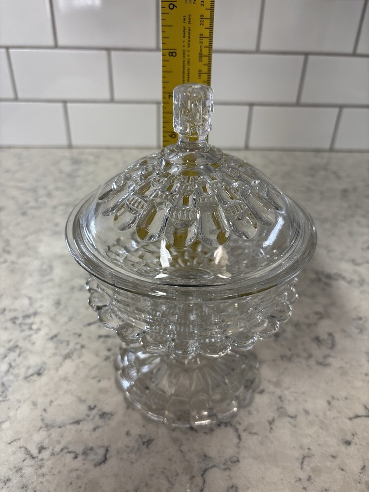 Clear pressed glass covered compote in the 'Cut Log' pattern.