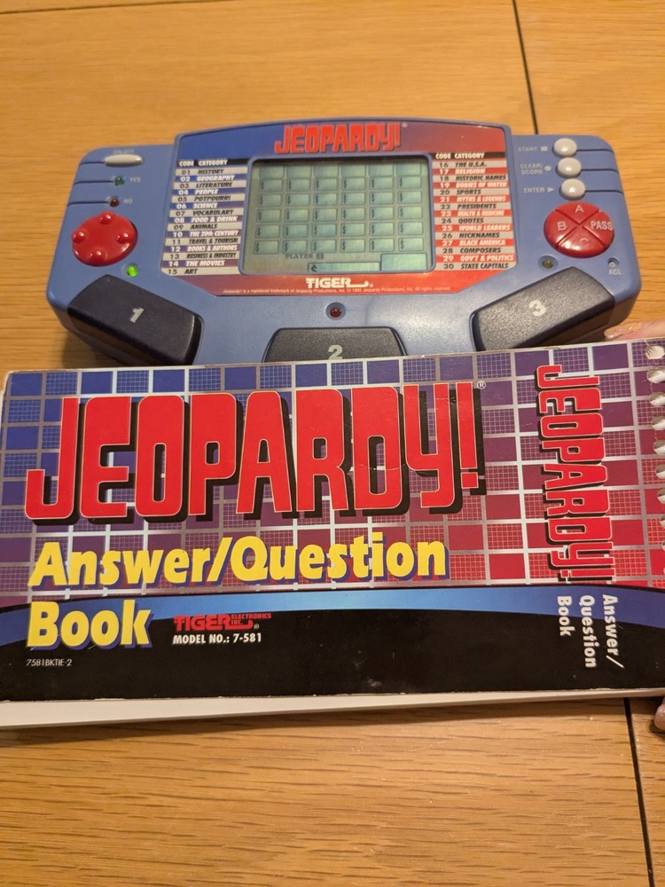 Tiger Electronics Jeopardy Hand Held Game 1995 with Answer Question Book