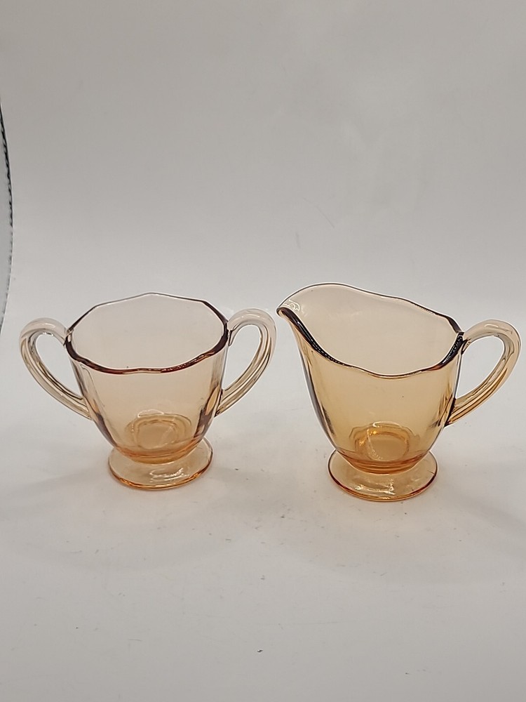 Pink iridescent creamor and open sugar footed.  Vintage
