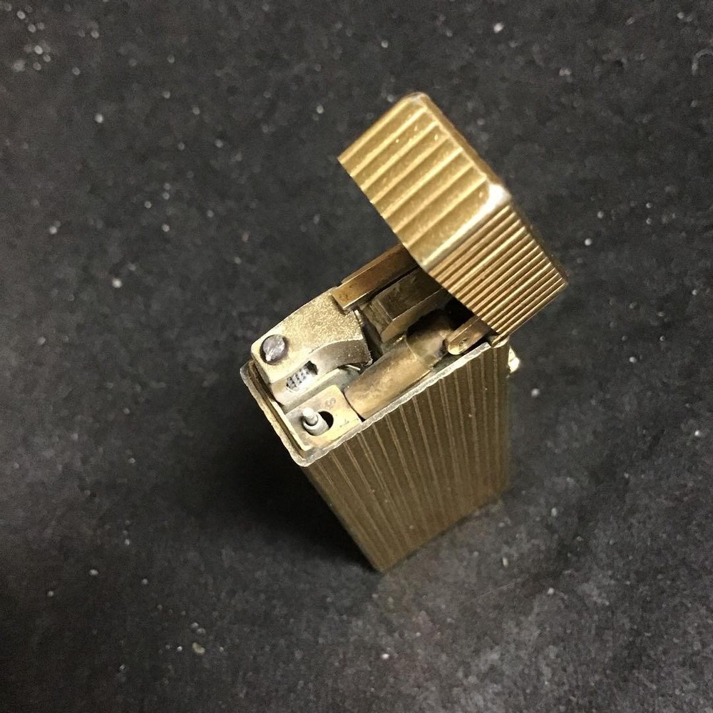 Overhauled gold dunhill lighter with striped pattern, ignition functioning well
