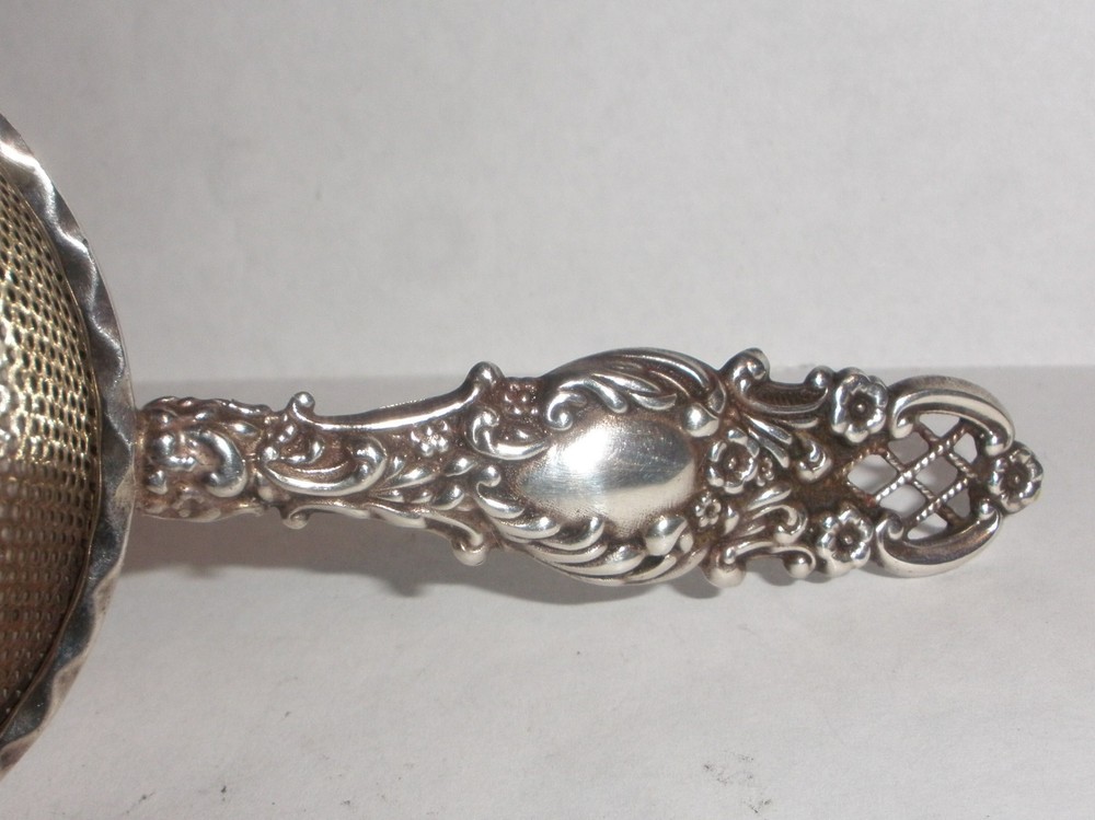 Nice Antique Continental silver flowers repousse tea strainer