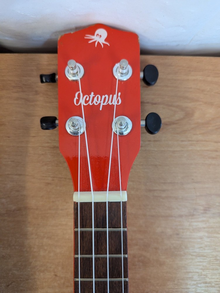 Octopus Soprano Ukulele Red with 4 Strings Includes Case for Beginners