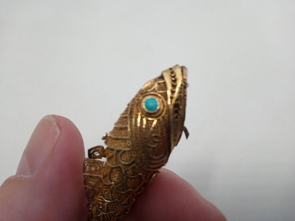 Tested as silver and gilded flexible fish, possibly pill box.