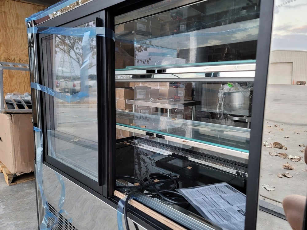 Multilevel refrigerated display case. Dessert, pastry, bakery display.