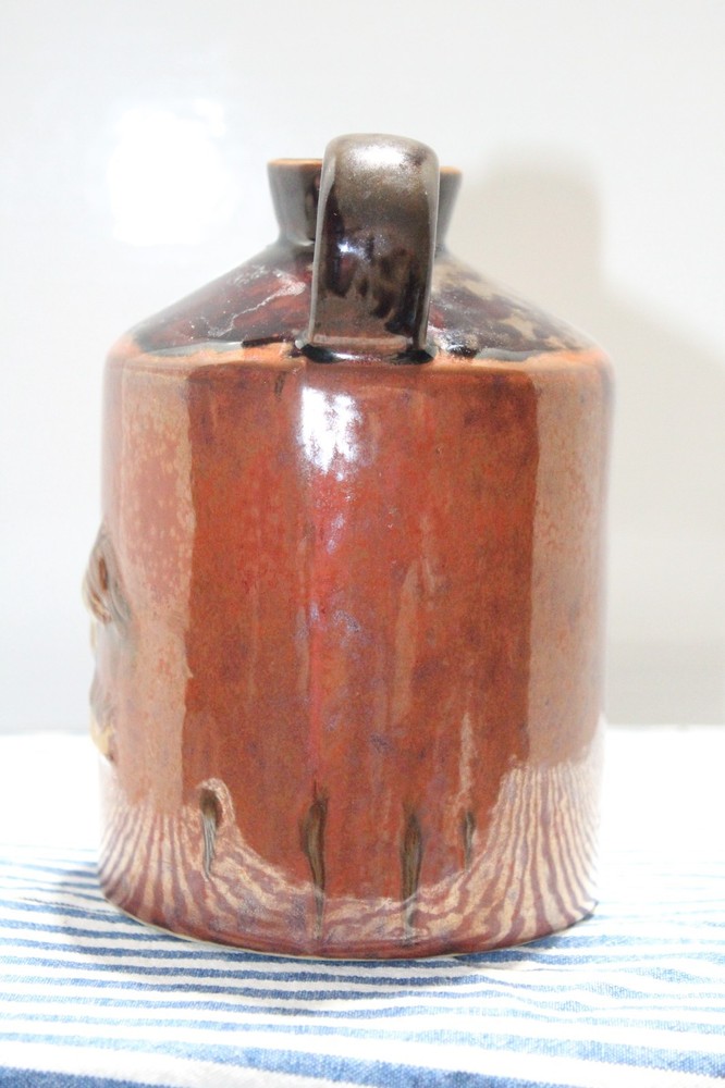 Brown Jug with Handle and a Chicken Design