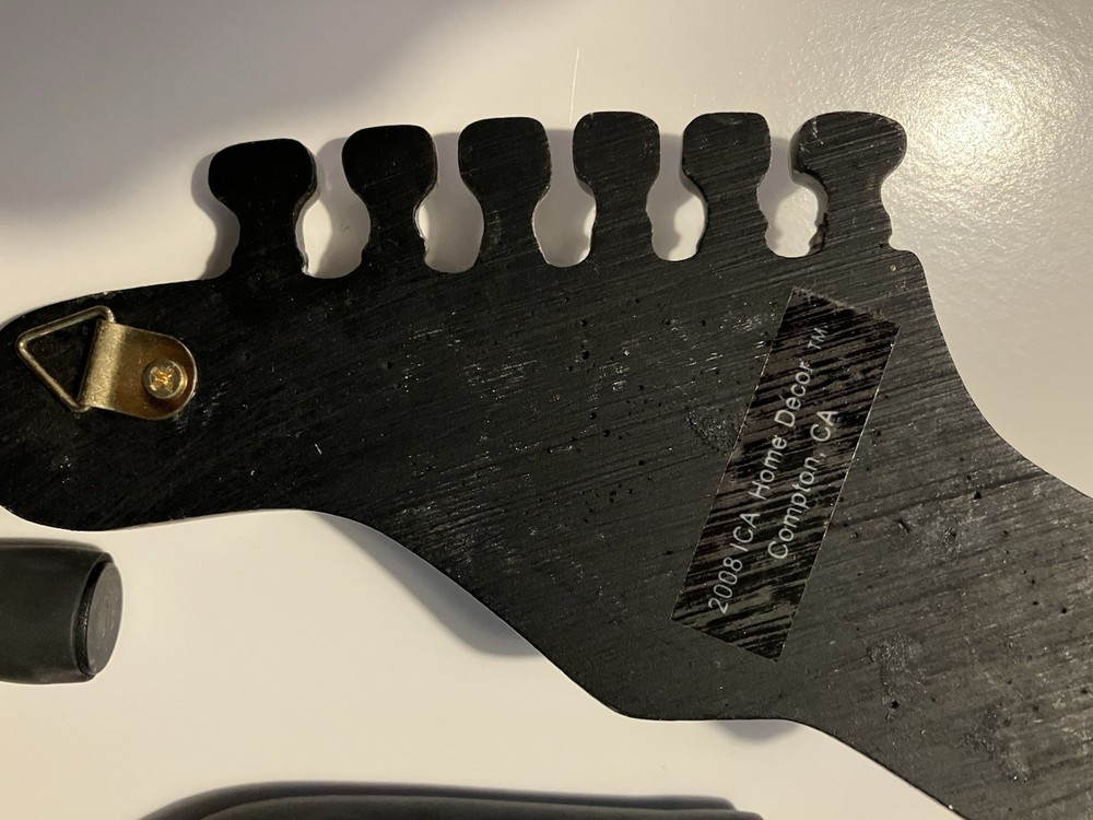 Three guitar wall hangers plus guitar hook