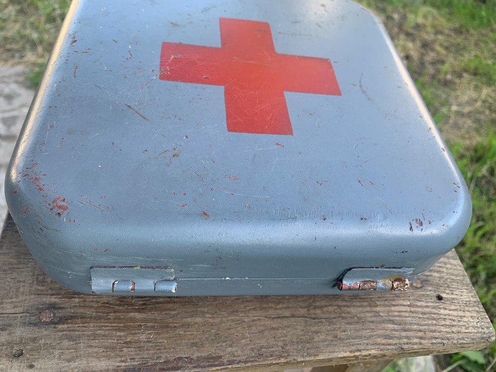 Old Soviet first aid kit with military equipment.