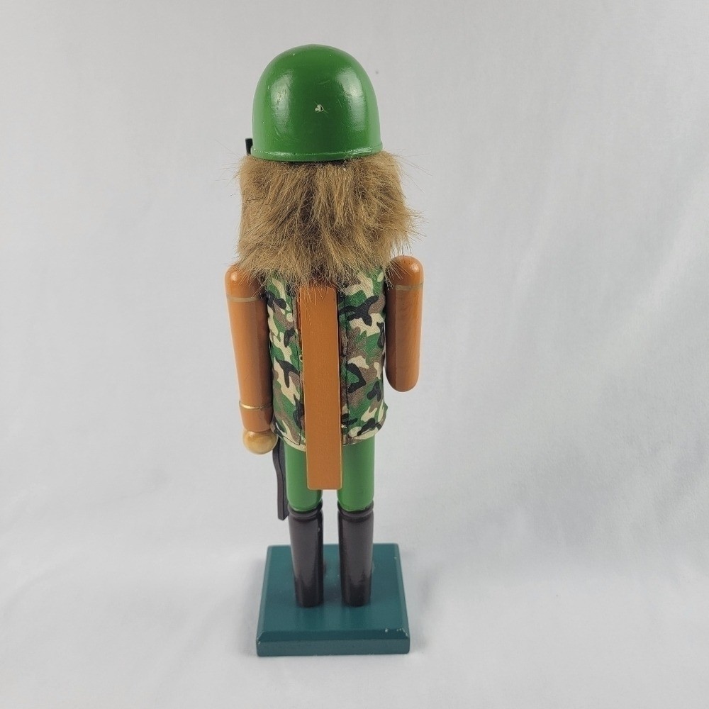 Wooden camouflage nutcracker with a rifle