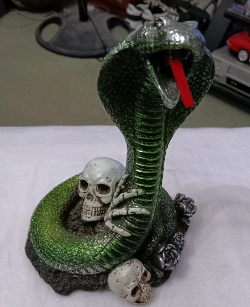 Green Cobra Snake On Skulls And Skeleton Statue