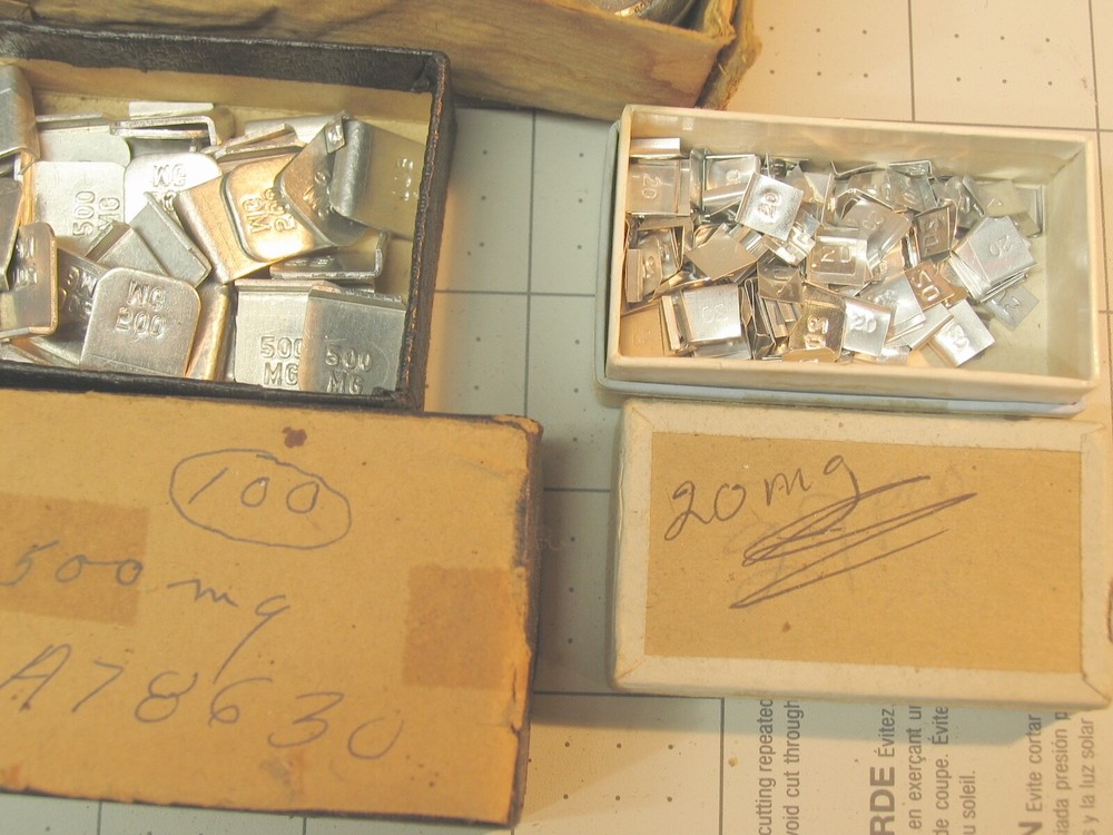 Collection of tiny marked weights 5mg-500mg.