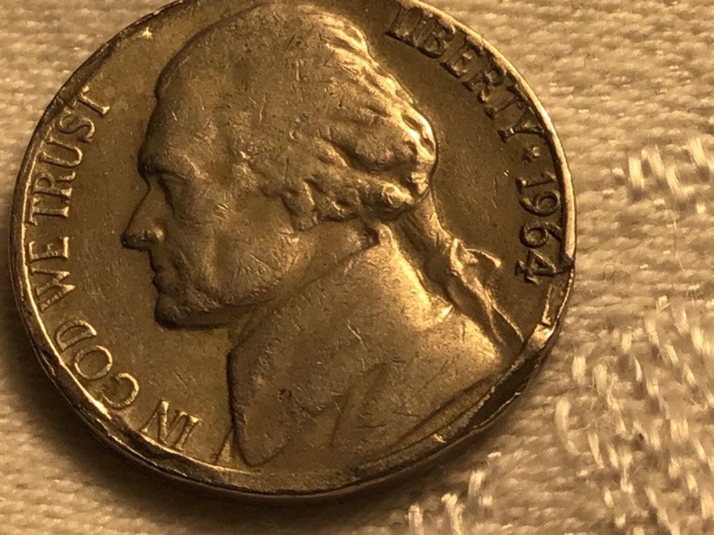 1964 jefferson nickle error on front and back edges.