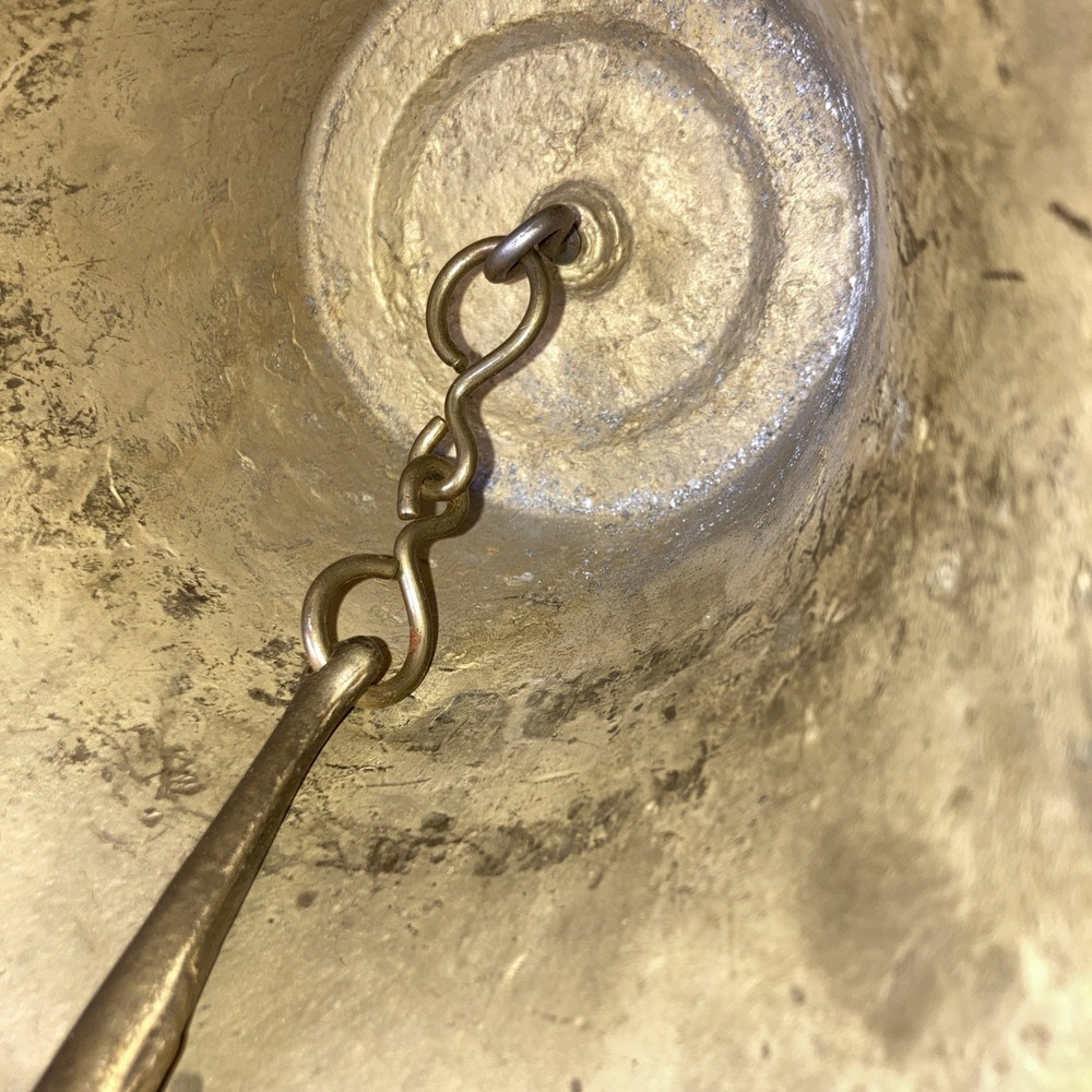 Heavy brass bell with Cupid on each side.