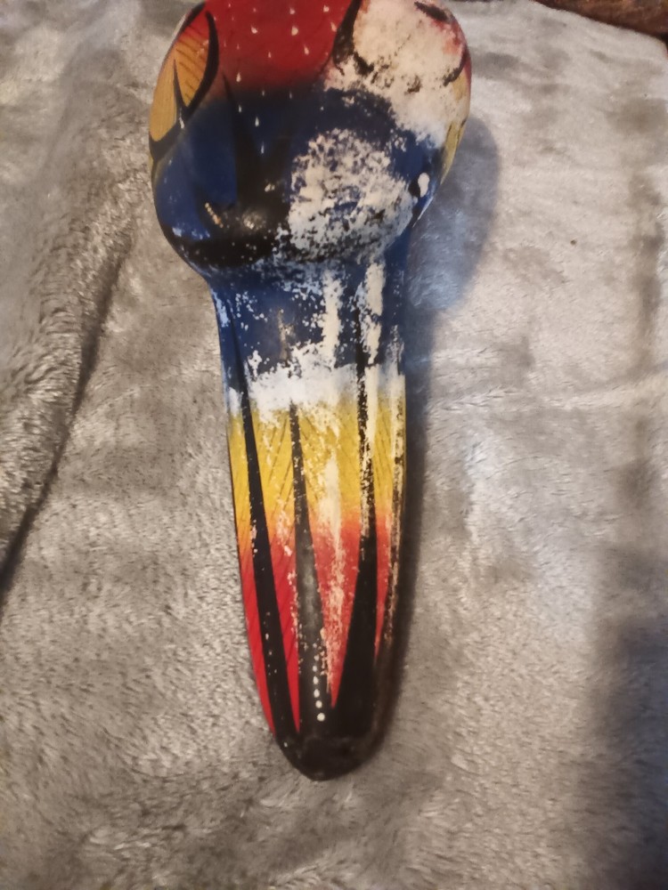 Worn painted ceramic parrot on metal perch,ceiling hanger.