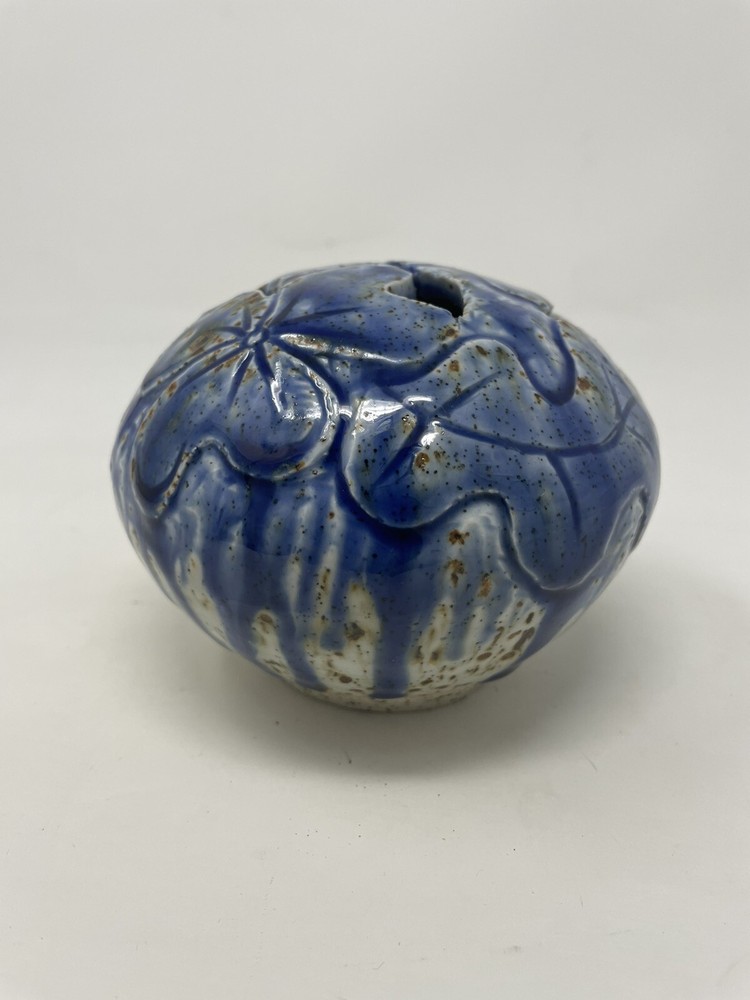 Pottery vase blue with brown specs .