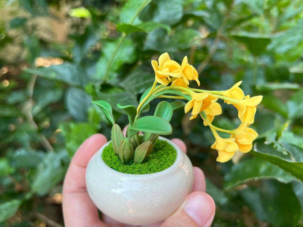 Tiny yellow orchids made by hand from clay