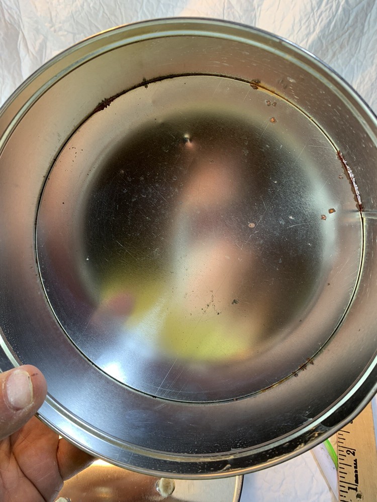 round silver tin with metal golf plaque affixed
