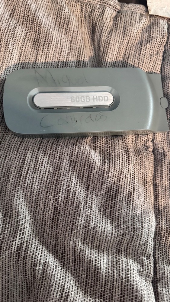 Microsoft Xbox 360 hard drive 60gb with some writing on the shell