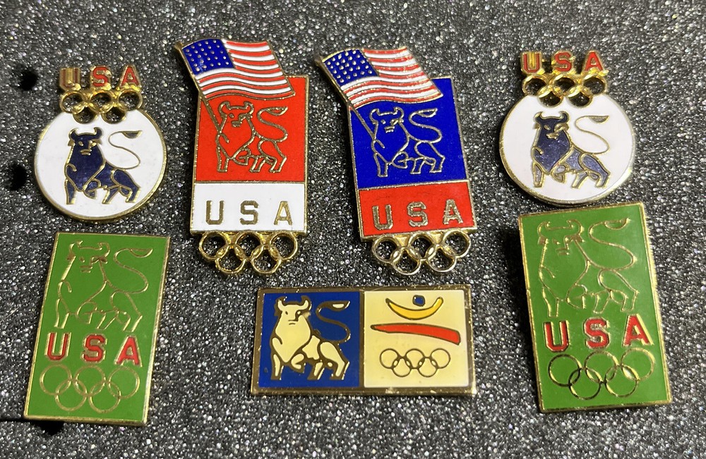 SEVEN (7) ASSORTED OLYMPICS PINS MERRILL LYNCH BULL