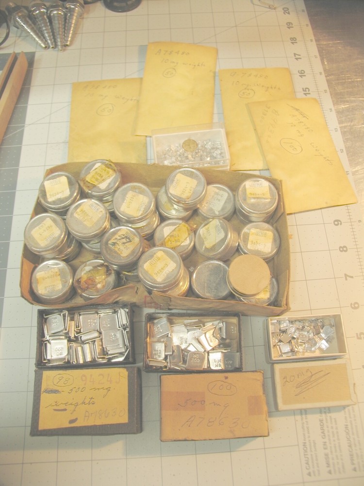 Collection of tiny marked weights 5mg-500mg.