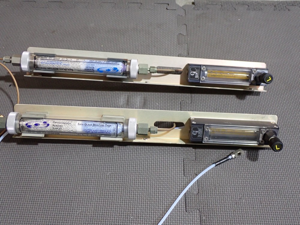 Gas flow regulators and desiccant