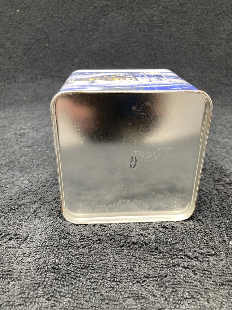 Winter mountain cabin scene tin