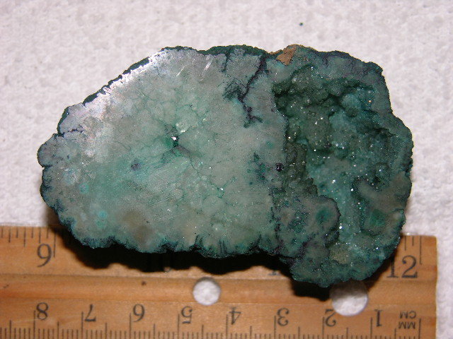 Geode cut & polished half with colored crystal center 2.5 inch E43