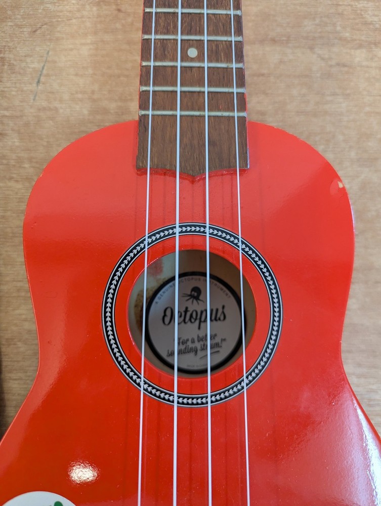 Octopus Soprano Ukulele Red with 4 Strings Includes Case for Beginners