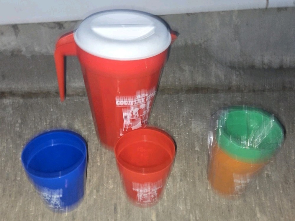 McNess Country Store.  Plastic Pitcher And 4 Plastic Cups