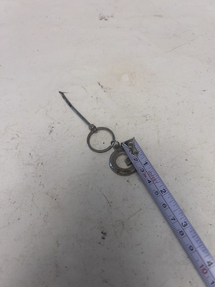 "G" keychain with small spoon scooper used
