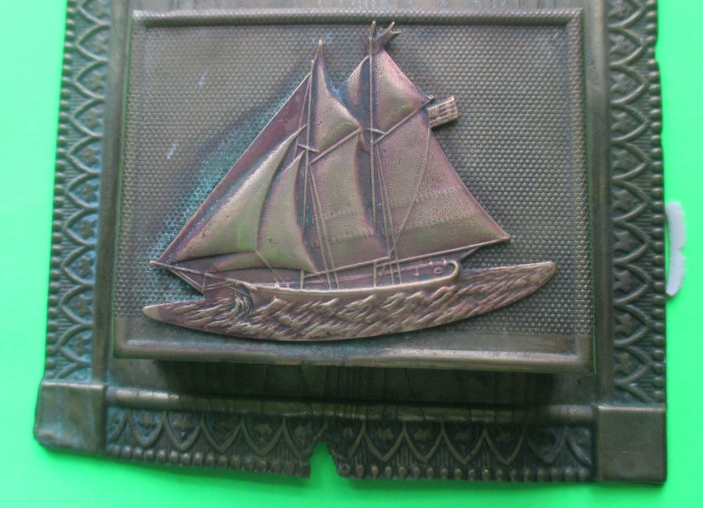 Old brass/tin wall mount match holder, with ship design