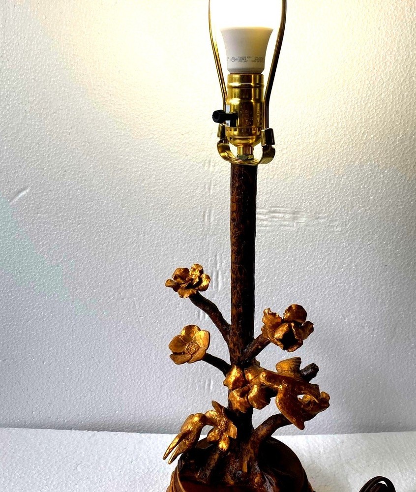Antique floral and bird table lamp featuring a rustic tree-branch stem