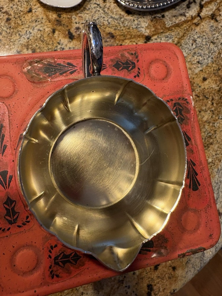 A vintage Oneida silver-plated fluted creamer with a decorative handle.