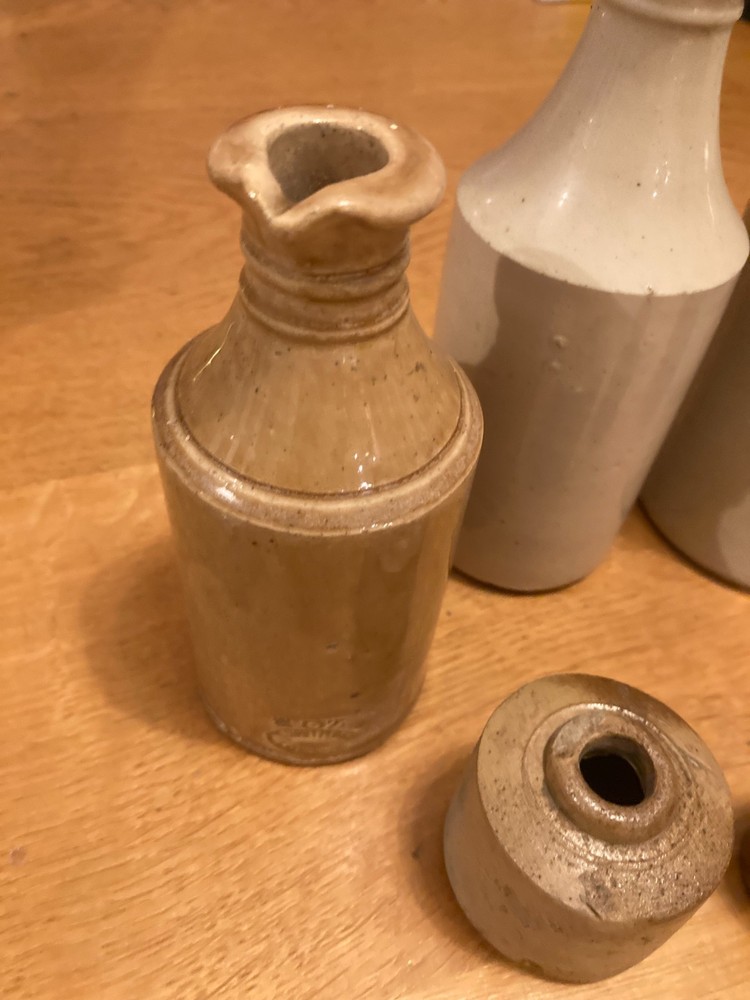 Vintage stone bottle collection in decent condition.