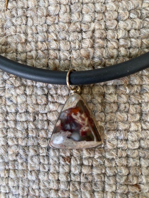 jasper triangular pendant set into silver, on a rubber necklace (Germany)