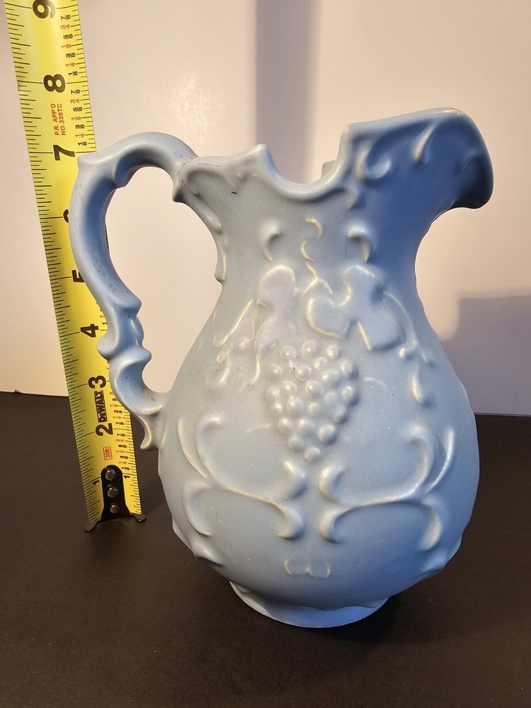 Blue Pitcher With Grapes And Leaves On The Side