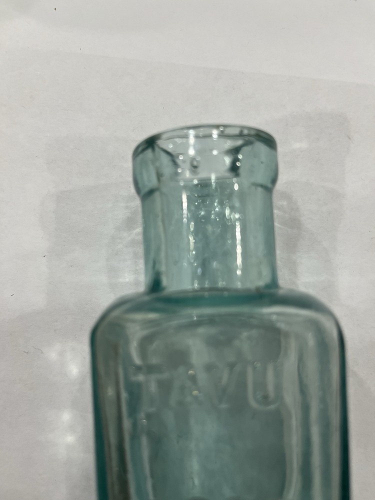 Embossed Aqua Kavu Boot Polish Bottle